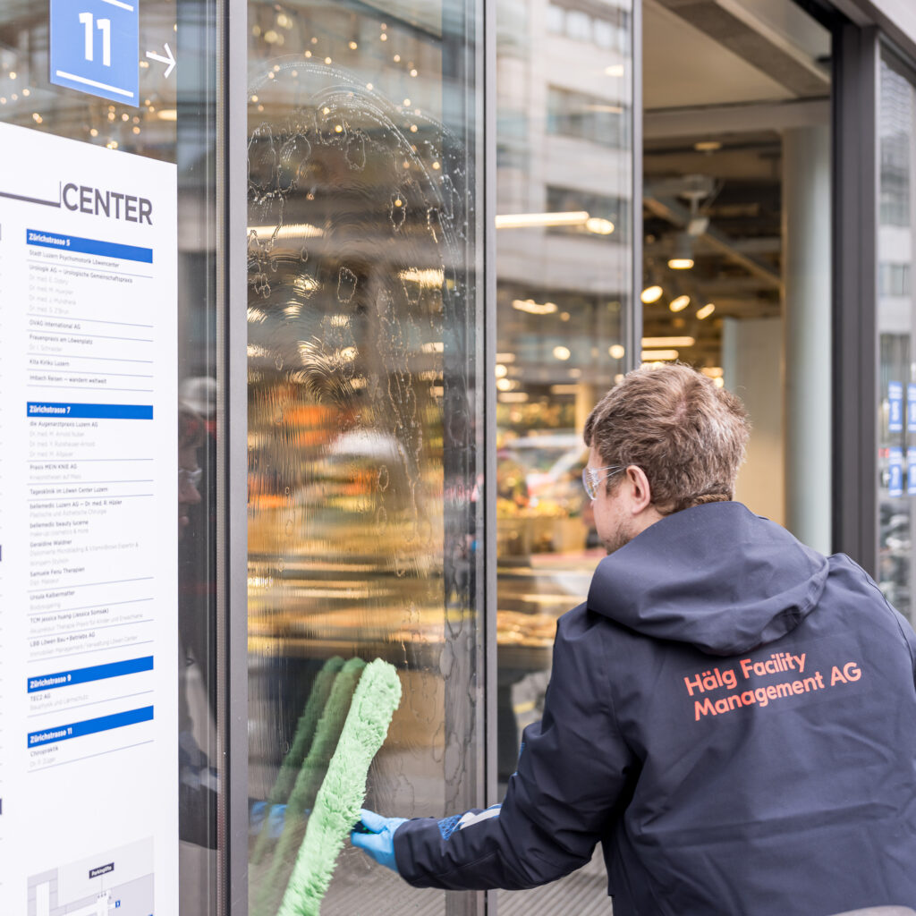 Ein Mitarbeiter der Hälg Facility Management AG bei der Fensterreinigung im Löwencenter in Luzern.